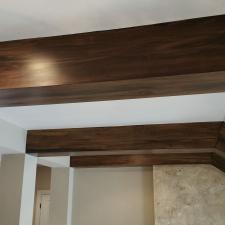 Faux wood ceiling beams and plaster fire place wall